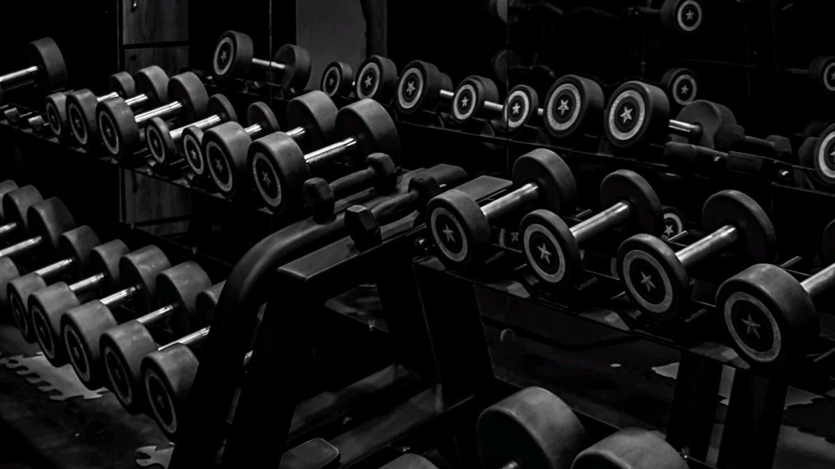 Hands gripping a barbell during a personal training session