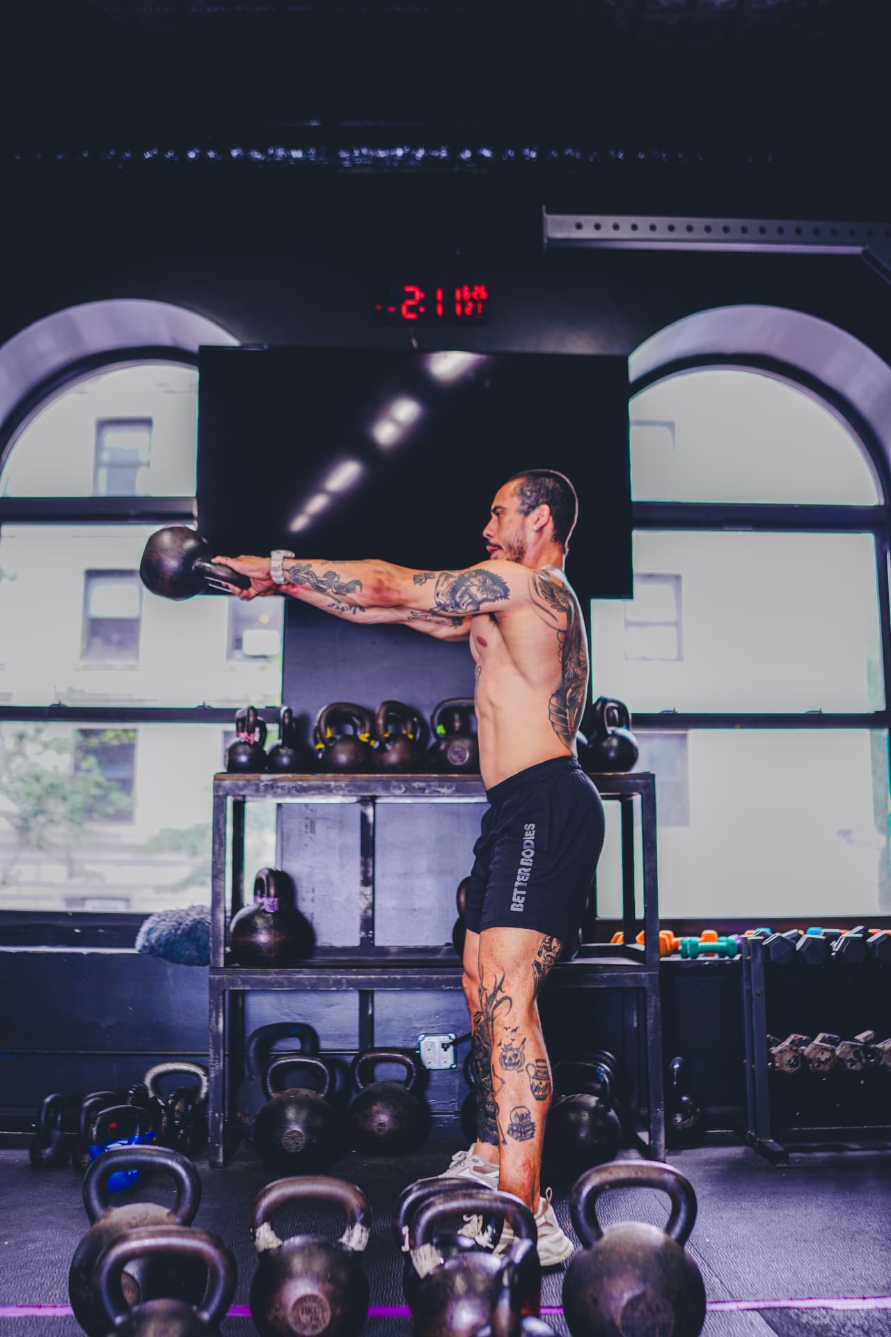 Athlete performing kettlebell swings at Strength Society